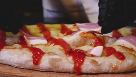 chef preparing a bacon pizza