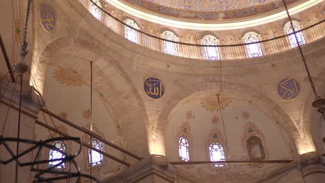 ornate interior of a historic mosque dome with calligraphy