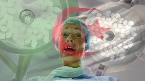 Animation-of-flag-of-algeria-waving-over-female-anesthesiologist-in-operating-theatre