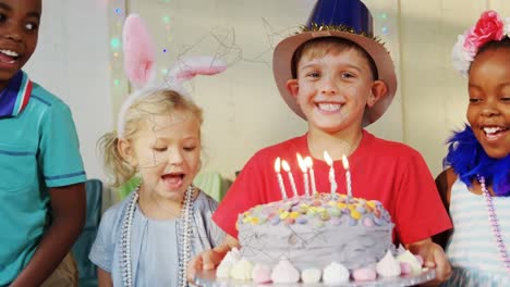 animation of shapes over diverse children with birthday cake at birthday party