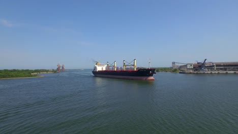 aerial shot of a big ship arriving to a port