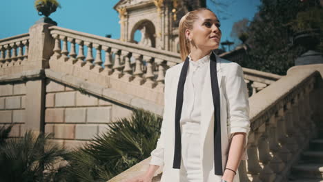 stylish young woman standing outdoors.