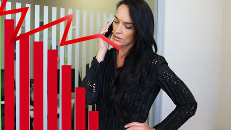 animation of red graphs over caucasian businesswoman using smartphone in office