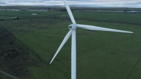 alternative green energy wind farm turbines spinning in frodsham cheshire fields aerial view high left orbit