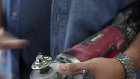 Close-up-shot-of-a-worker-changing-the-pad-on-a-machine-polisher