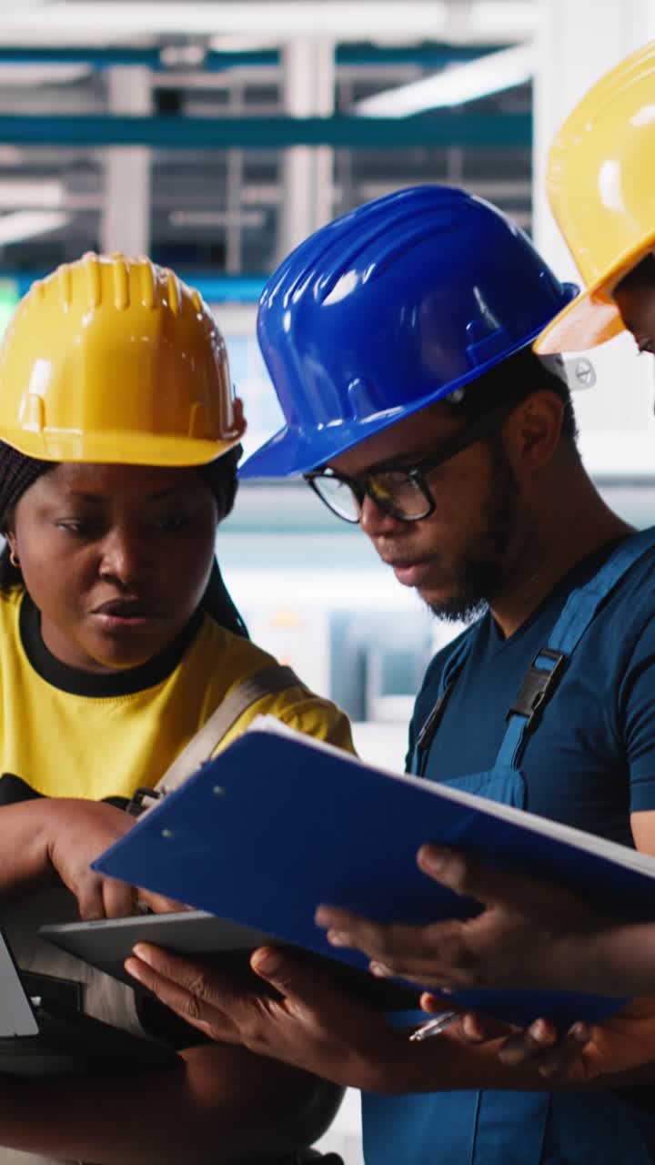 Vertical Video Technicians group in photovoltaics factory use tracking software on devices