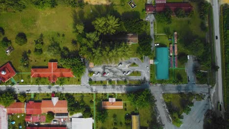 Cinematic-Drone-Footage-of-Palm-Oil-Mill-Effluent-residential-consists-of-buildings,-homes,-main-road-and-infrastructure-surrounded-by-palm-oil-trees-deforestation-located-in-Indonesia-in-full-HD