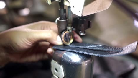 shoemaking - shoemaker sewing leather parts of shoes