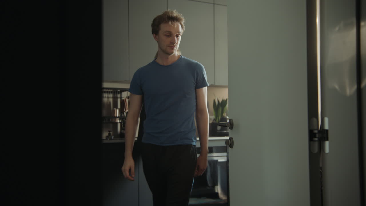 Man Walking Through Kitchen Door