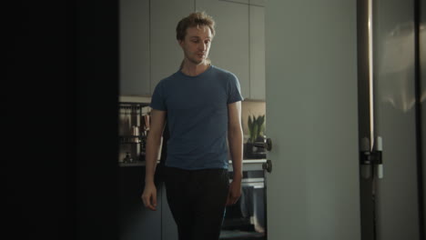 man walking through kitchen door