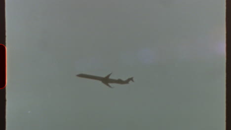 filmed on super 8 film - vintage airplane flying through clouds with super 8 film look, lens flares and film grain, creating a nostalgic and retro aesthetic