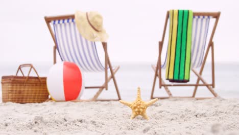 deck chairs and starfish on the sand