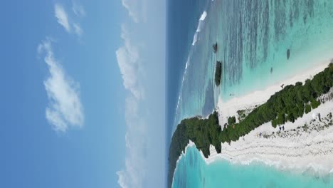 vertical aerial above dhigurah island along its long white sandbank and turquoise clear water, maldives