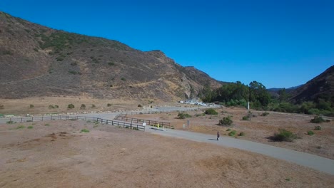 Aerial-footage-following-a-man-riding-an-electric-unicycle-down-a-road-in-California-1