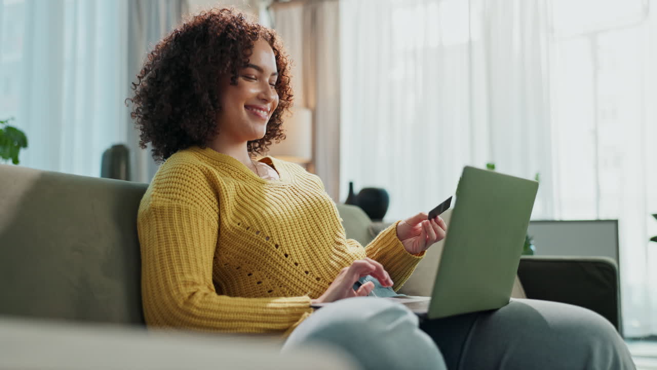Woman using laptop and credit card for online shopping