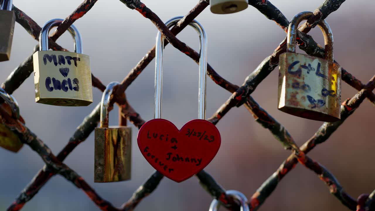 Close up of a Red and heart shaped Love lock in a fence in Montmartre Paris during summer days.