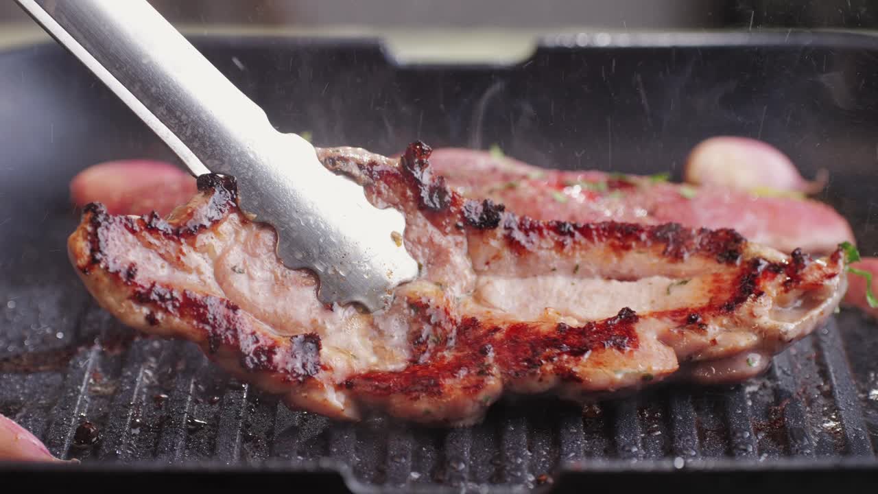 Cooking raw turkey meat in spices with garlic and greens on grill close-up. Fry chicken or turkey slice on frying pan Grilled chicken, duck, turkey kebab with vegetables.