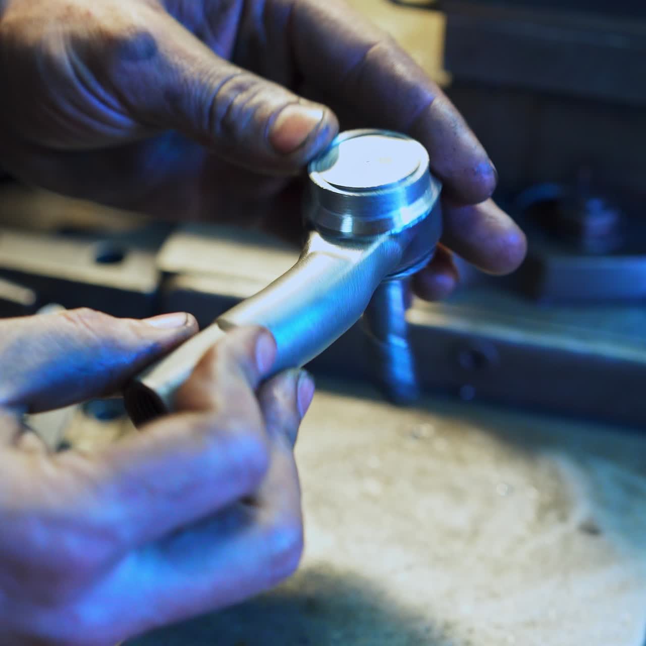 Turner's hands adjusting metal piece to a detail. Turner checking the compatibility of grinded details. Close up