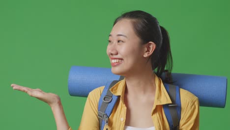 woman with backpack and yoga mat