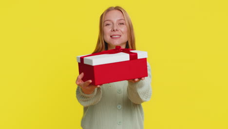 smiling woman presenting birthday gift present box stretches out hands promotion discount sale