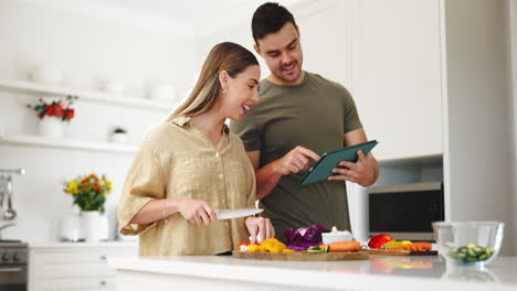 Food,-tablet-and-a-couple-cooking-in-the-kitchen