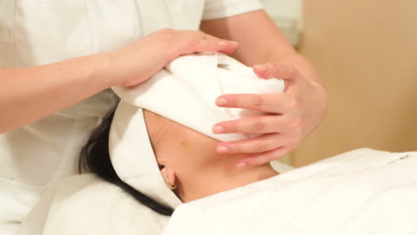 woman getting face therapy at beauty salon