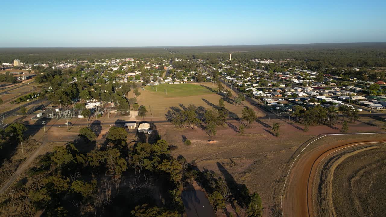 Left to right aerial views over sporting fields and residential housing, Miles Queensland.