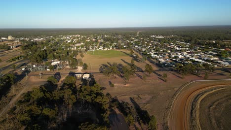 left to right aerial views over sporting fields and residential housing, miles queensland.