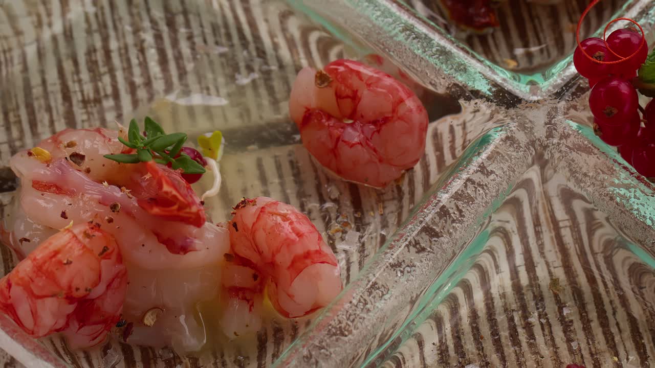 A top view close-up of shrimps laying on an aperitif plate, showcasing Mediterranean style snacks in Taormina, Sicily, Italy (Taormina, Sicilia, Italia)