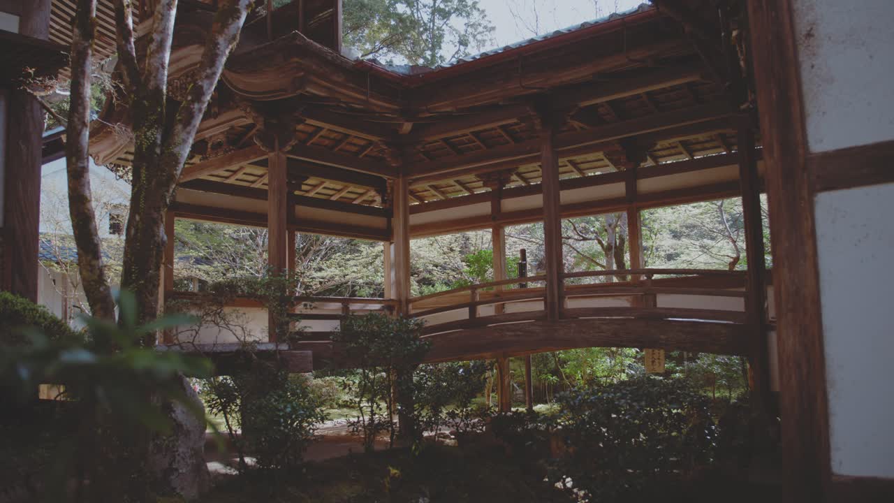 A beautiful Japanese temple at Takaosan, showcasing traditional wooden architecture surrounded by lush greenery. T