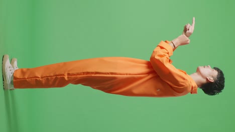 hombre en jumpsuit naranja señalando