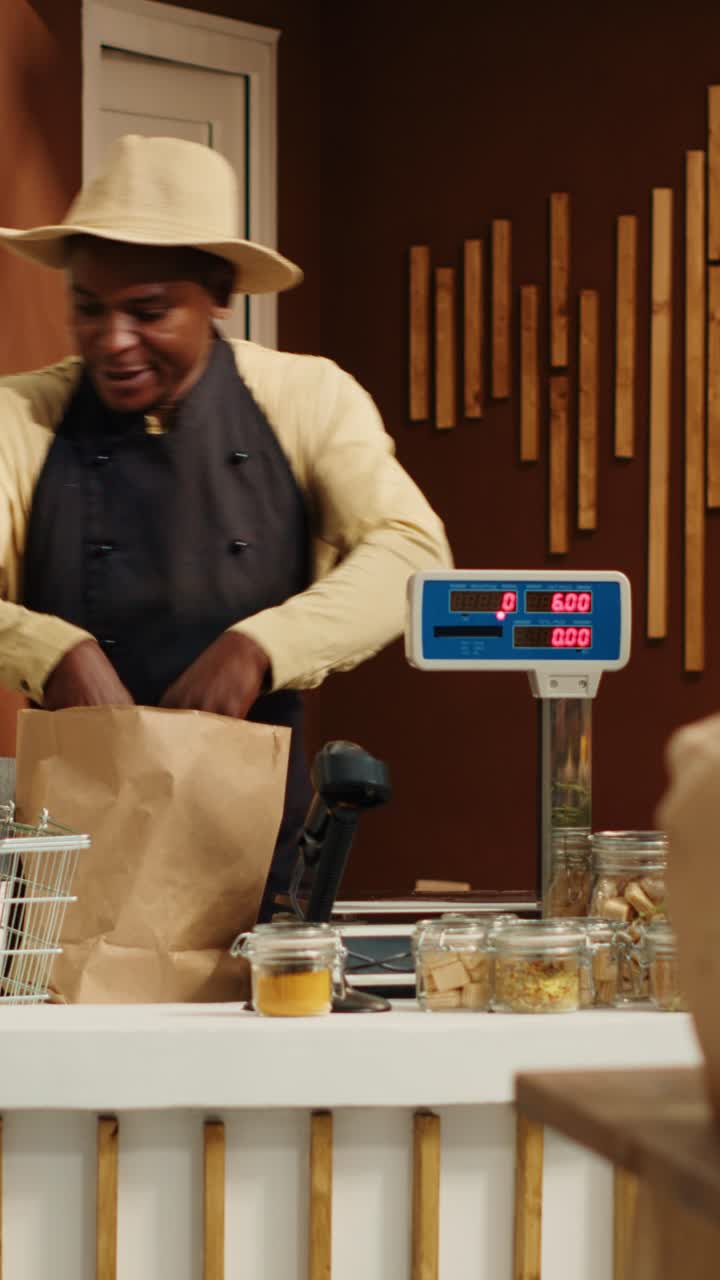 Vertical Video Vendor weighting goods for customer at cash register in store