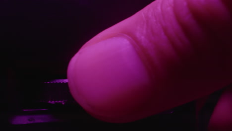 finger pressing tuning button on a vintage radio
