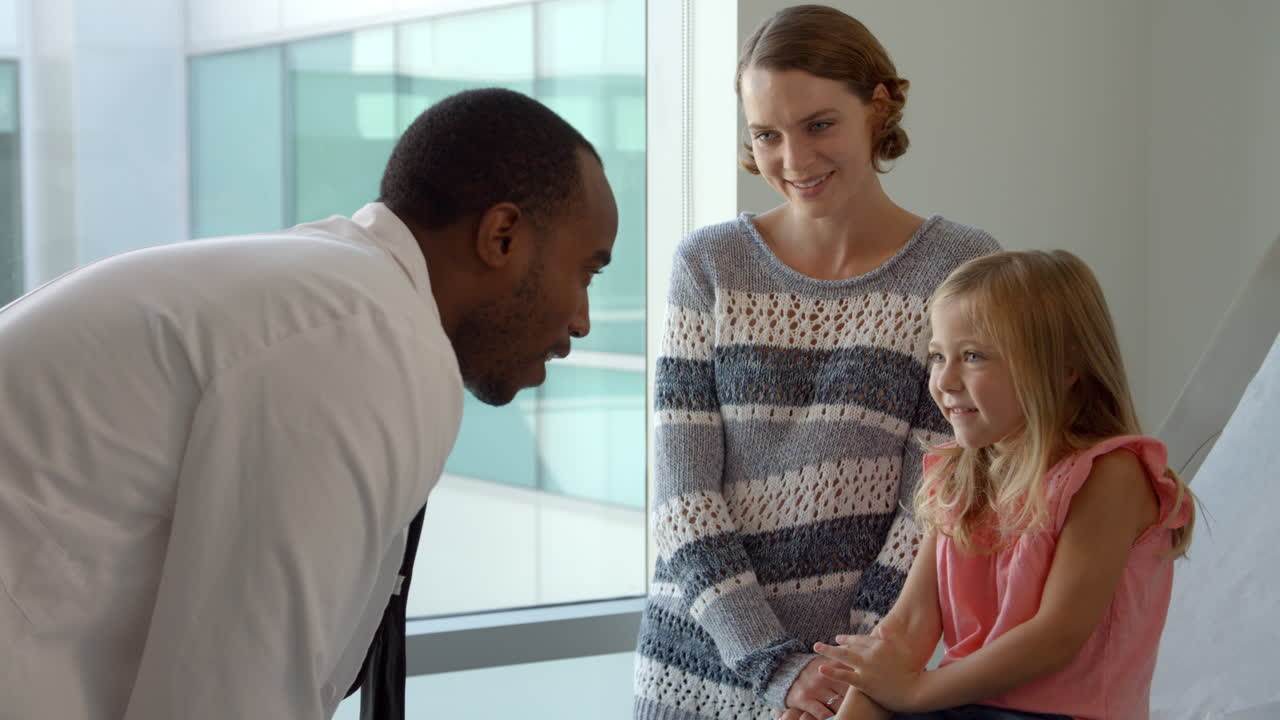 Pediatrician Meets With Mother And Daughter In Hospital