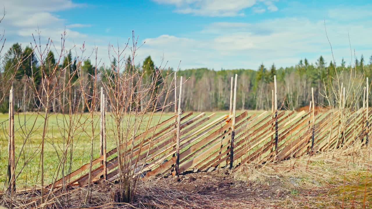 Time-lapse Of A Man Installing Skigard, Norwegian Fence On A Sunny Day