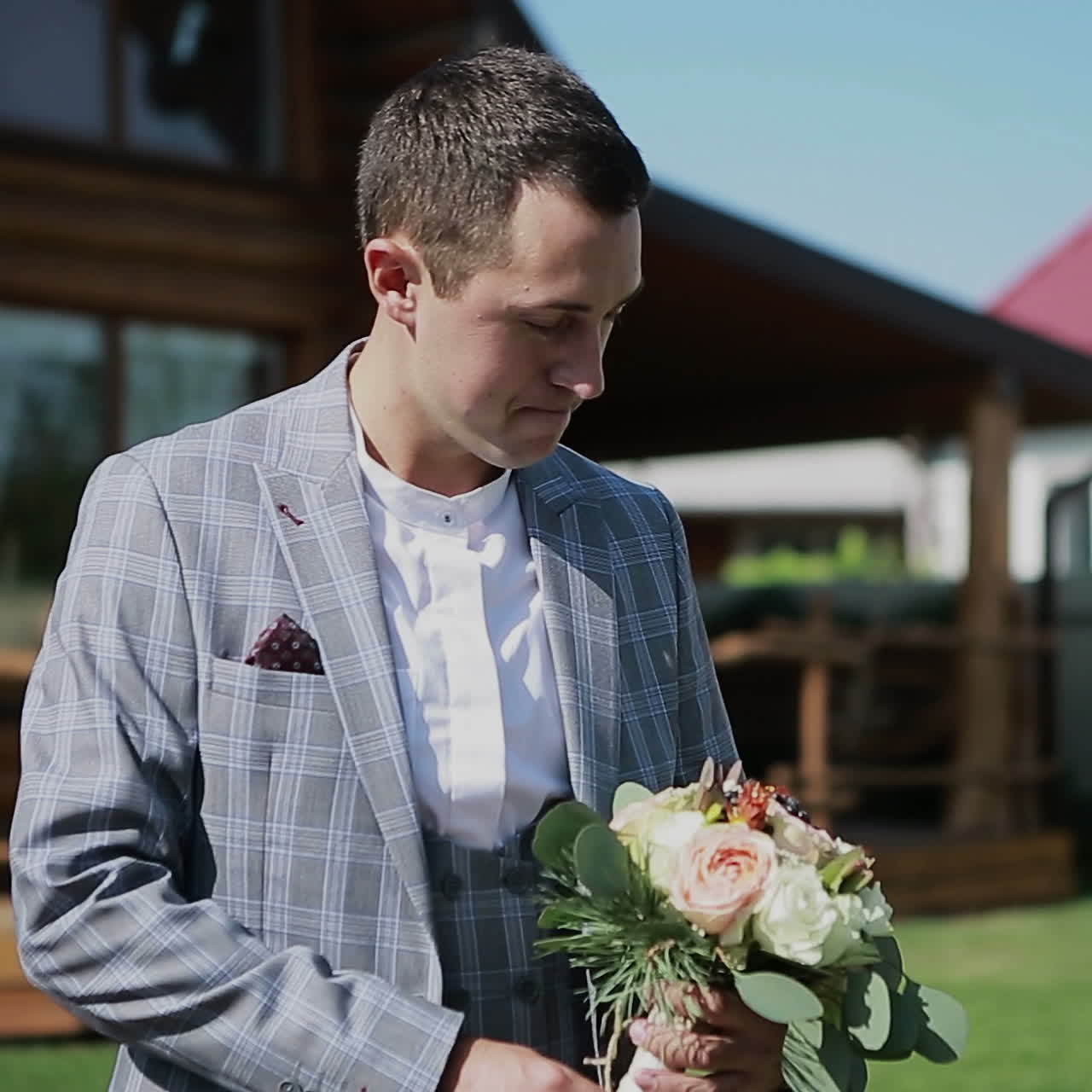 Handsome man holding a bouquet. Groom prepares for a wedding Square video