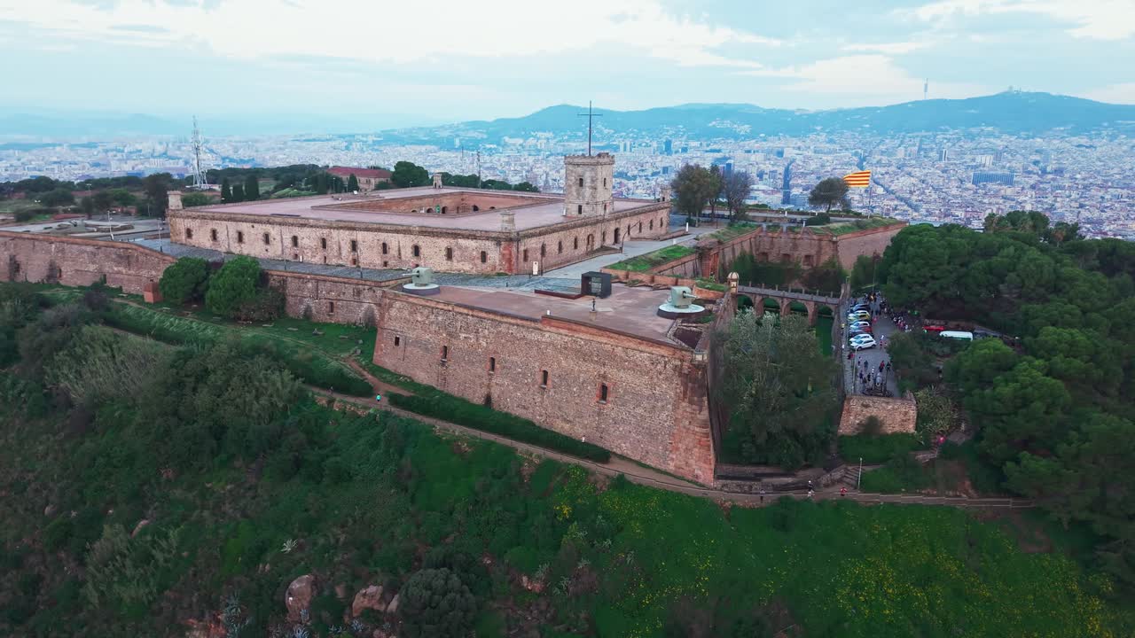 Montjuic castle above Barcelona city center, aerial orbit