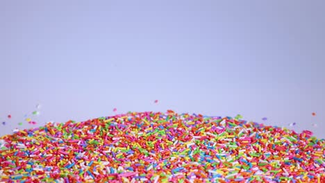 vibrant sprinkles cascade onto a growing mound