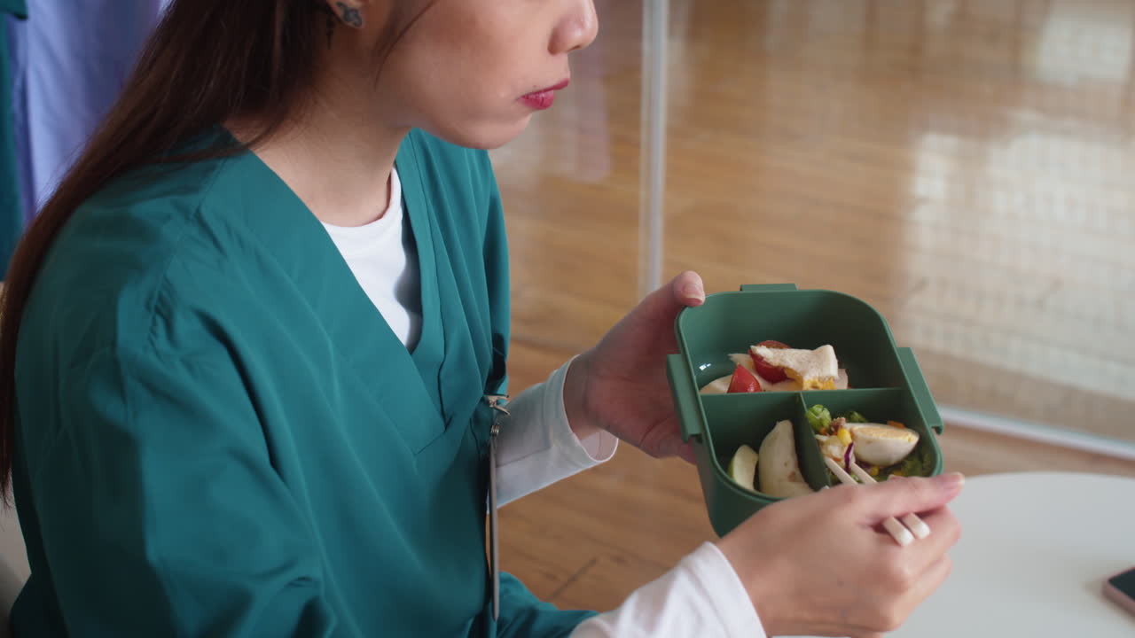 Female Medical Worker Eating Lunch in Hospital