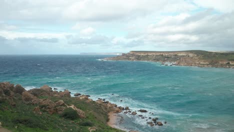 AERIAL:-Beautiful-Turquoise-Colour-Sea-Water-Rolls-Waves-to-Ghajn-Tuffieha-Bay