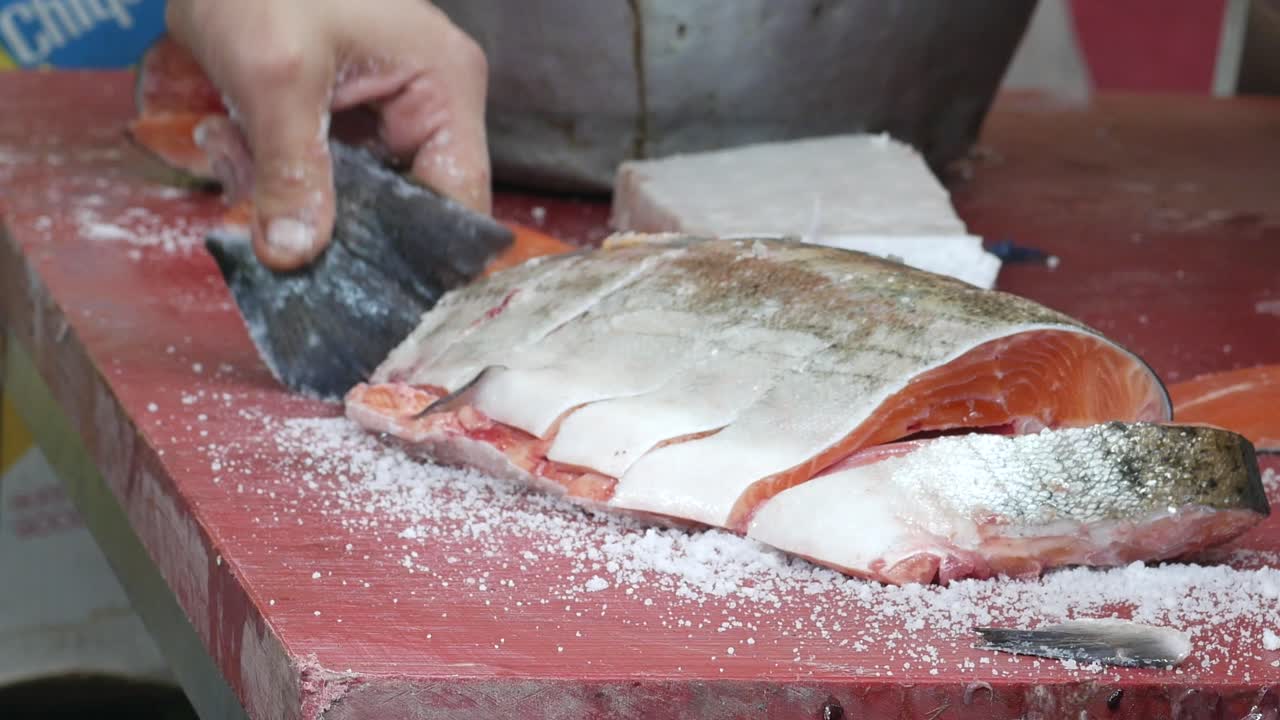Butcher Cutting Fresh Salmon Fillet