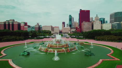 aerial view of buckingham memorial fountain orbiting and discovering city life of chicago, illinois, usa