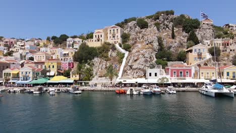 waterfront promenade and harbor of island symi on a beautiful summer day