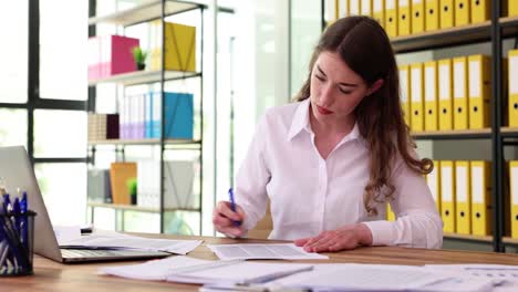 professional woman working on paperwork in a modern office