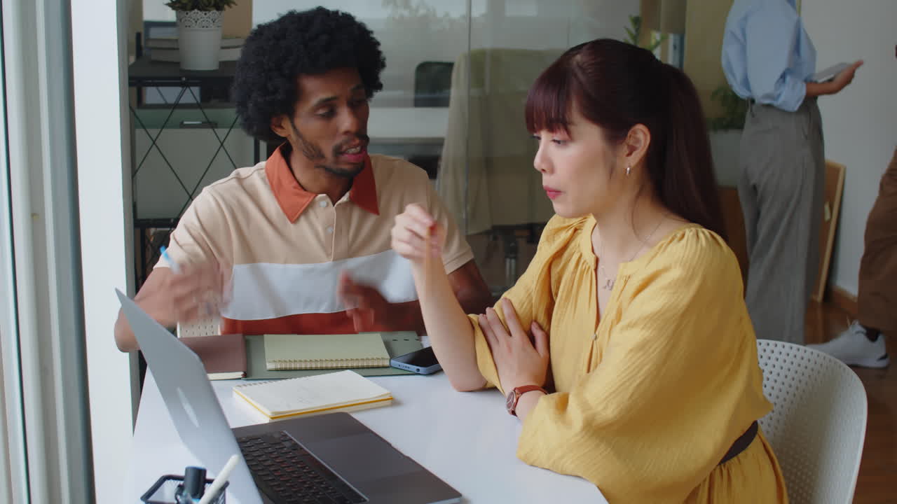 Biracial Colleagues Working in Modern Startup Office