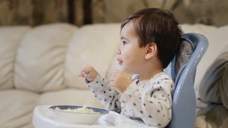 very independent asian kid eats potatoes