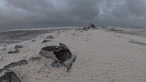 cyclone alfred - sea foam blown by strong wind at currumbin beach during cyclone in queensland, australia. - wide shot