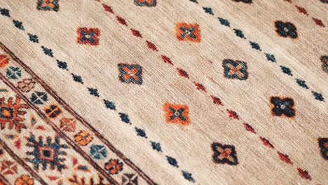 close up of a patterned rug being vacuumed