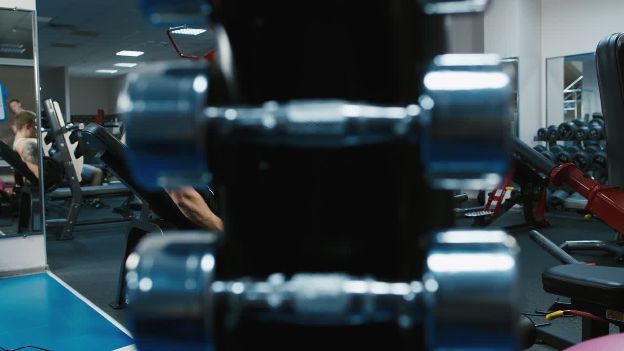 A young athlete trains his legs in the gym