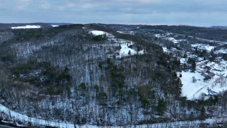 aerial orbit around snow covered mountain in winter
